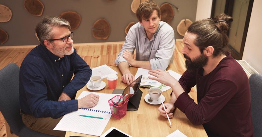 Three men working at the office